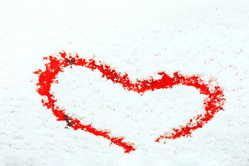 Heart painted on the snow-covered windshield of a car. Copy space.