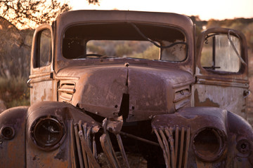 old rusty car wreck in the desert 