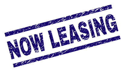 NOW LEASING seal print with scratced style. Blue vector rubber print of NOW LEASING label with scratched texture. Text label is placed between parallel lines.