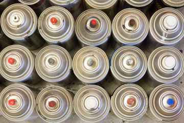 Overhead of spray paint cans in line