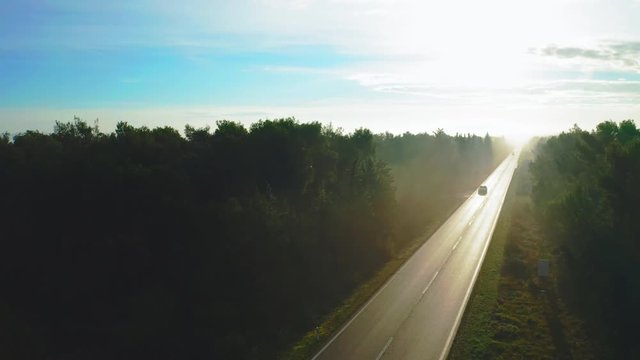Traffic on a road in the outskirts of Pakostane at dawn. Zadar Croatia. Aerial view tilt down