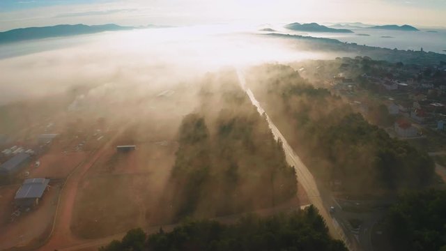 Beautiful view of the outskirts of Pakostane at sunrise with some mist. Zadar Croatia. Aerial view travelling backwards