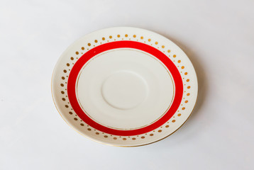 a white round plate with floral and line pattern on white background