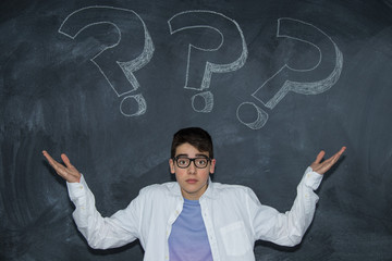 young teenager on the blackboard with question mark