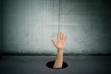 hand asking for help in the hole