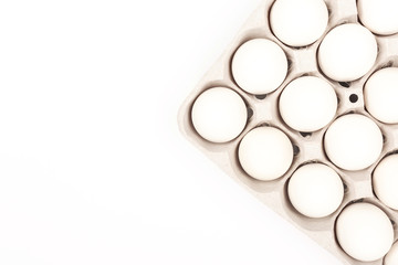 Eggs in egg box on white background
