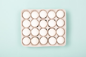 Eggs in egg box on mint background