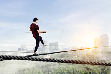 Obraz premium Brave ropewalker on cable. Mixed media