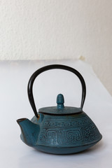 Blue traditional Chinese cast iron teapot on white background