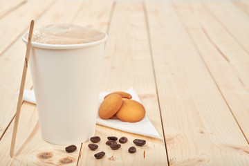 coffee with cookies on a wooden table