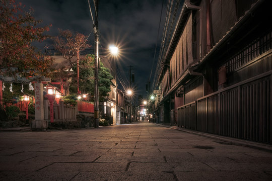 Traditional Japanese Buildings At Night In Autumn On A Narrow Street In Gion District, Kyoto, Japan.