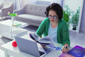 Nice good looking woman studying special literature