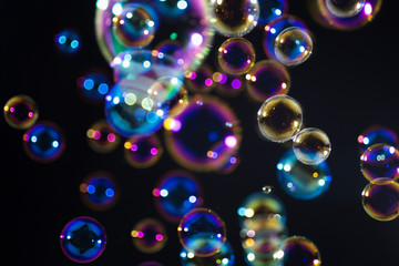 colorful soap bubbles floating in the dark.