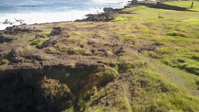 Aerial Footage over Ahu Vai Uri and Ahu Tahai Moais platforms at Easter Island. A close drone pass through the Moais statues and the coastline. Amazing the history behind the Moai and the traditions