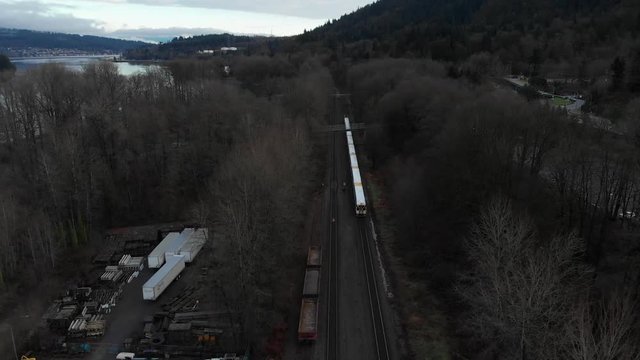 Various drone shots around Barnet Marine Park in Burnaby, British Columbia, Canada. Beautiful lush green trees and sandy shores along Pacific Ocean inlet.