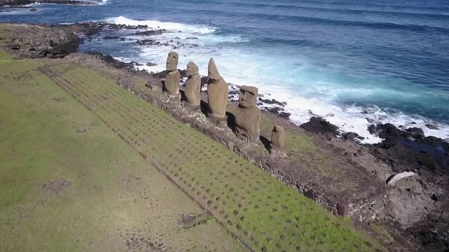 Aerial Footage over Ahu Vai Uri and Ahu Tahai Moais platforms at Easter Island. A close drone pass through the Moais statues and the coastline. Amazing the history behind the Moai and the traditions