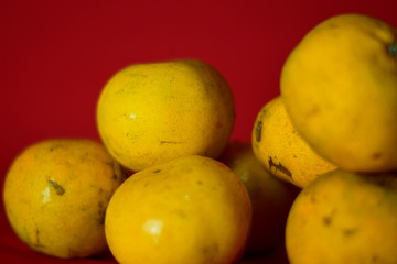 Fresh orange fruit in the red background
