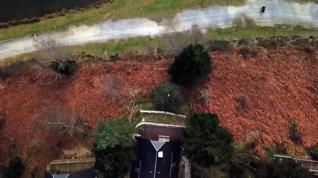 drone view of three lake houses looking onto water
