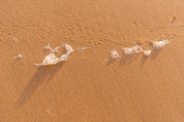 White foam in the sand.