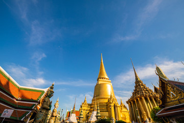 Fototapeta premium Temple of the emerald buddha golden pagoda with blue sky cloud