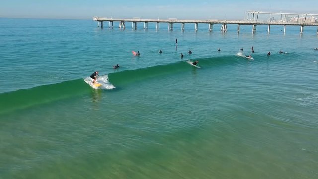 A large group of surfers enjoying the waves
