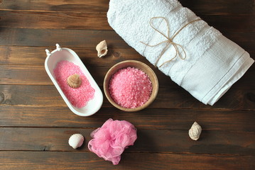 Dead Sea cosmetics. Spa and body care products. Aromatic rose bath Dead Sea Salt on the dark wooden background. Natural ingredients for homemade body salt scrub. Beauty skin care. 