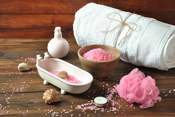 Dead Sea cosmetics. Spa and body care products. Aromatic rose bath Dead Sea Salt on the dark wooden background. Natural ingredients for homemade body salt scrub. Beauty skin care. 