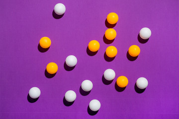 Fototapeta na wymiar White and orange balls on a purple background