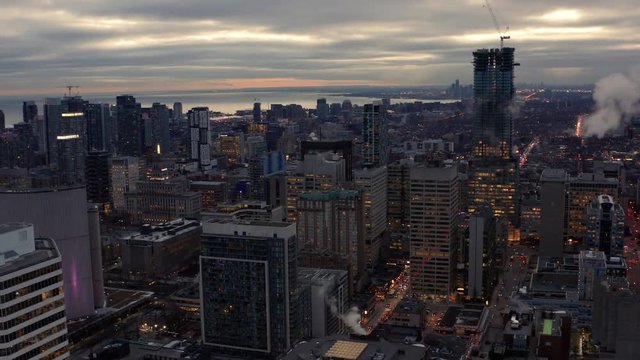 Downtown winter sunset aerial moving back downtown core over Dundas square Toronto Canada