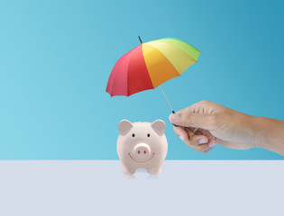 pink piggy ceramic bank with colorful rainbow umbrella, safe insurance