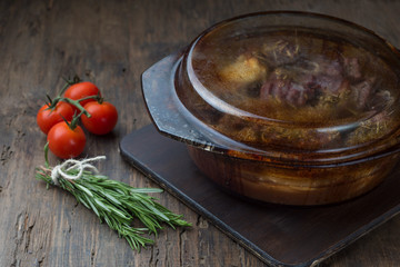 Goulash, beef stew in glass  baking dish on dark background,
