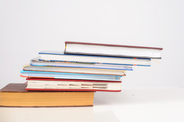 educational books are stacked in the form of a ladder on the table