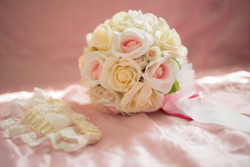 Bridal bouquet of white roses, on a pink bed, short focus