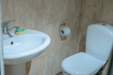 bathroom in a village house with a white toilet, sink and soap
