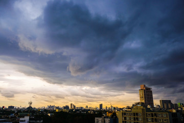 Fototapeta na wymiar Raining cloud over skyscraper of modern city building