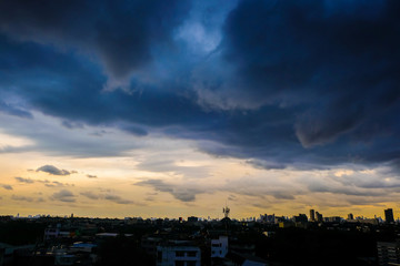 Raining cloud over skyscraper of modern city building