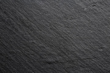 Extreme close up of the texture of a dark stone kitchen board