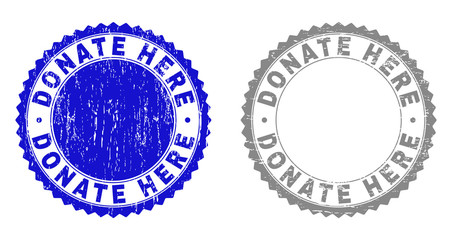 Grunge DONATE HERE stamp seals isolated on a white background. Rosette seals with grunge texture in blue and grey colors. Vector rubber stamp imprint of DONATE HERE caption inside round rosette.