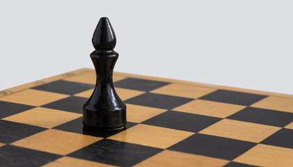 Black chess Bishop on a chess Board