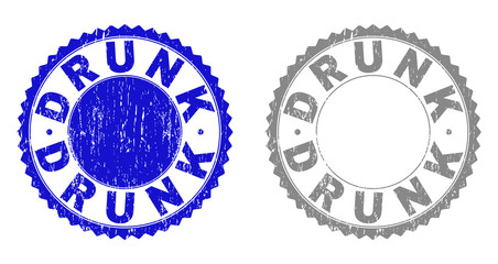 Grunge DRUNK stamp seals isolated on a white background. Rosette seals with grunge texture in blue and grey colors. Vector rubber stamp imprint of DRUNK title inside round rosette.