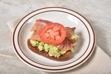Open faced bacon avocado sandwich