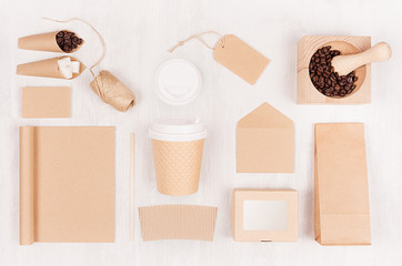 Eco friendly coffee template for design, advertising and branding - brown paper cup, blank notebook, box, sugar, card, beans on white wood board.