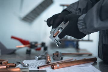 Engineer is holding in hands a pipe rammer tool. Pipework.