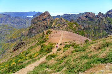 Fototapeta premium Couple of people walking in the mountains. Mountain landscape. Madeira, Portugal.