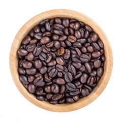 Coffee beans in wooden bowl isolated on white. Elephant dung coffee. Top view.