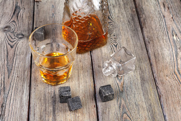 Whiskey beverage in glass with stone. Alcohol background