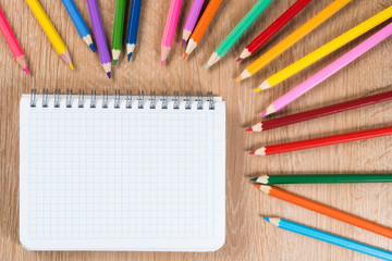 Idea of school still life with pencils and notebook on desk