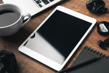 electronic gadgets and office supplies on wooden table
