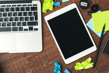 electronic gadgets and office supplies on wooden table