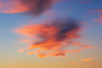 Colorful purple clouds in sky at sunset in summer